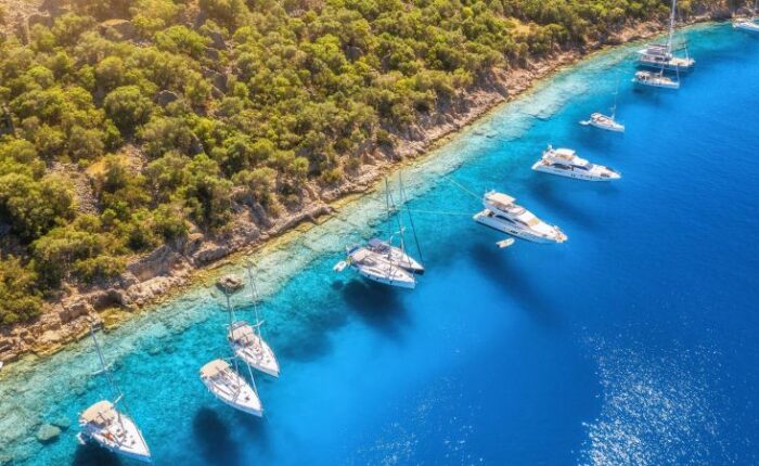 Yachts and boats in Bodrum the clear blue sea Bodrum near Gemiler Island at sunset, Turkish Riviera