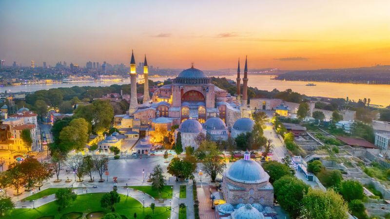 Hagia Sophia and Blue Mosque with Istanbul skyline at sunset, Turkey