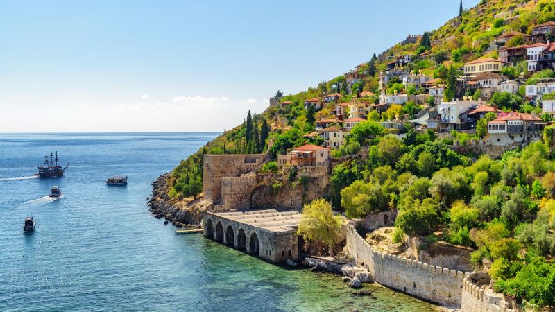 View of Alanya Tersane (shipyard) and boats by the coast in Alanya, Turkey